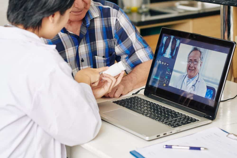 Nurse recommending tablets to patient Nurse recommending tablets to patient