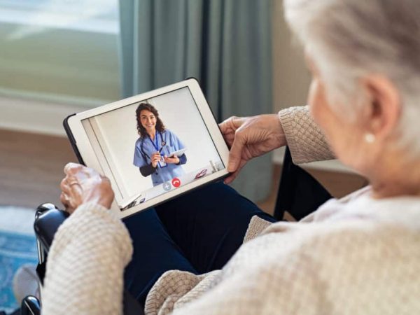 Doctor on video call with disabled senior patient